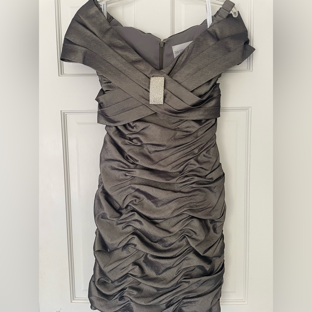 David’s cocktail dress.  Rouched fitted flattering-stretchy fabric gives a bit.